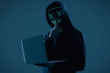 anonymous-man-black-hoodie-neon-mask-hacking-into-computer-728x486