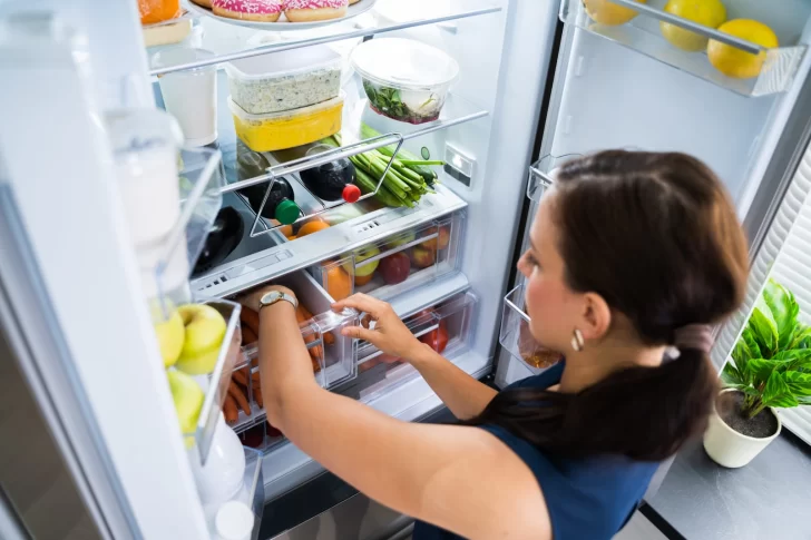 79606456_women-looking-for-food-inside-fridge-728x485